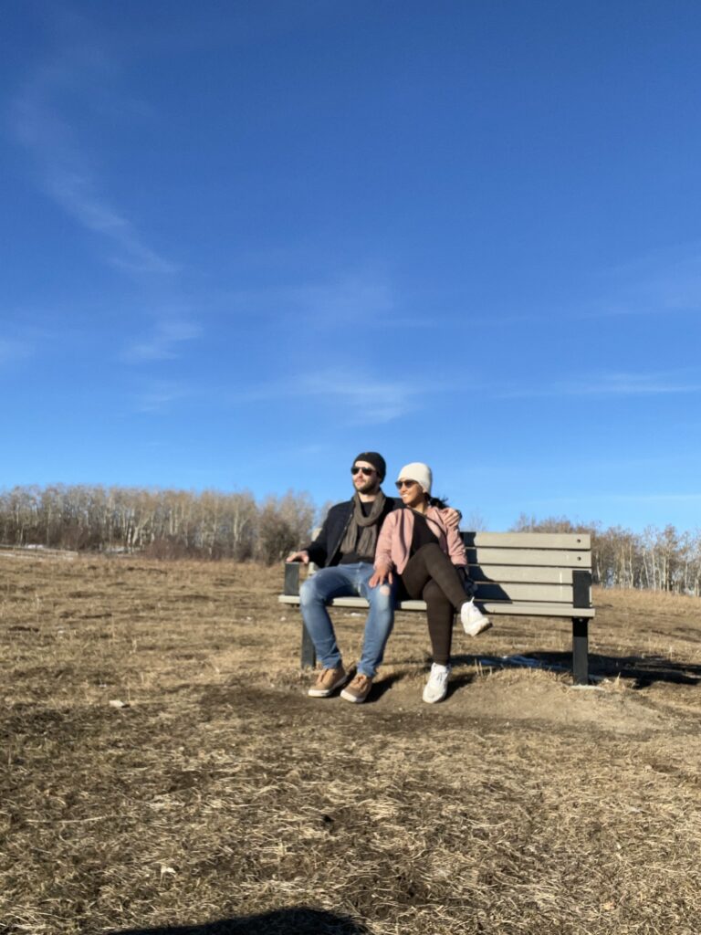 Us sitting on a bench at Ann & Sandy Cross Conservation